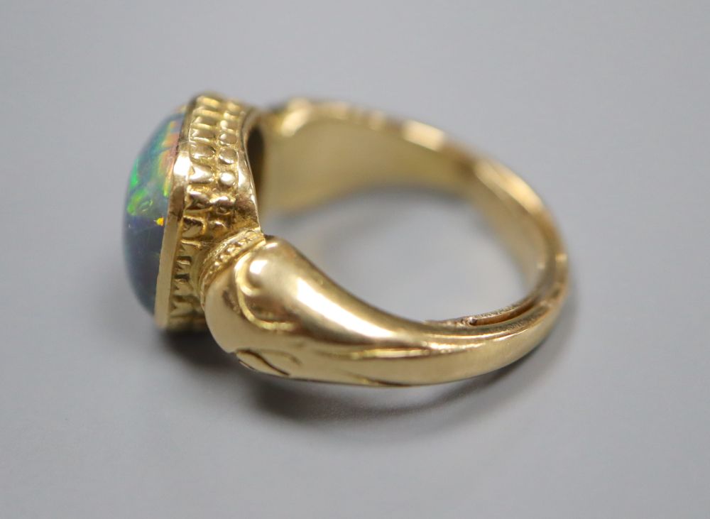 A yellow metal and opal set dress ring, size I, gross 7.4 grams.